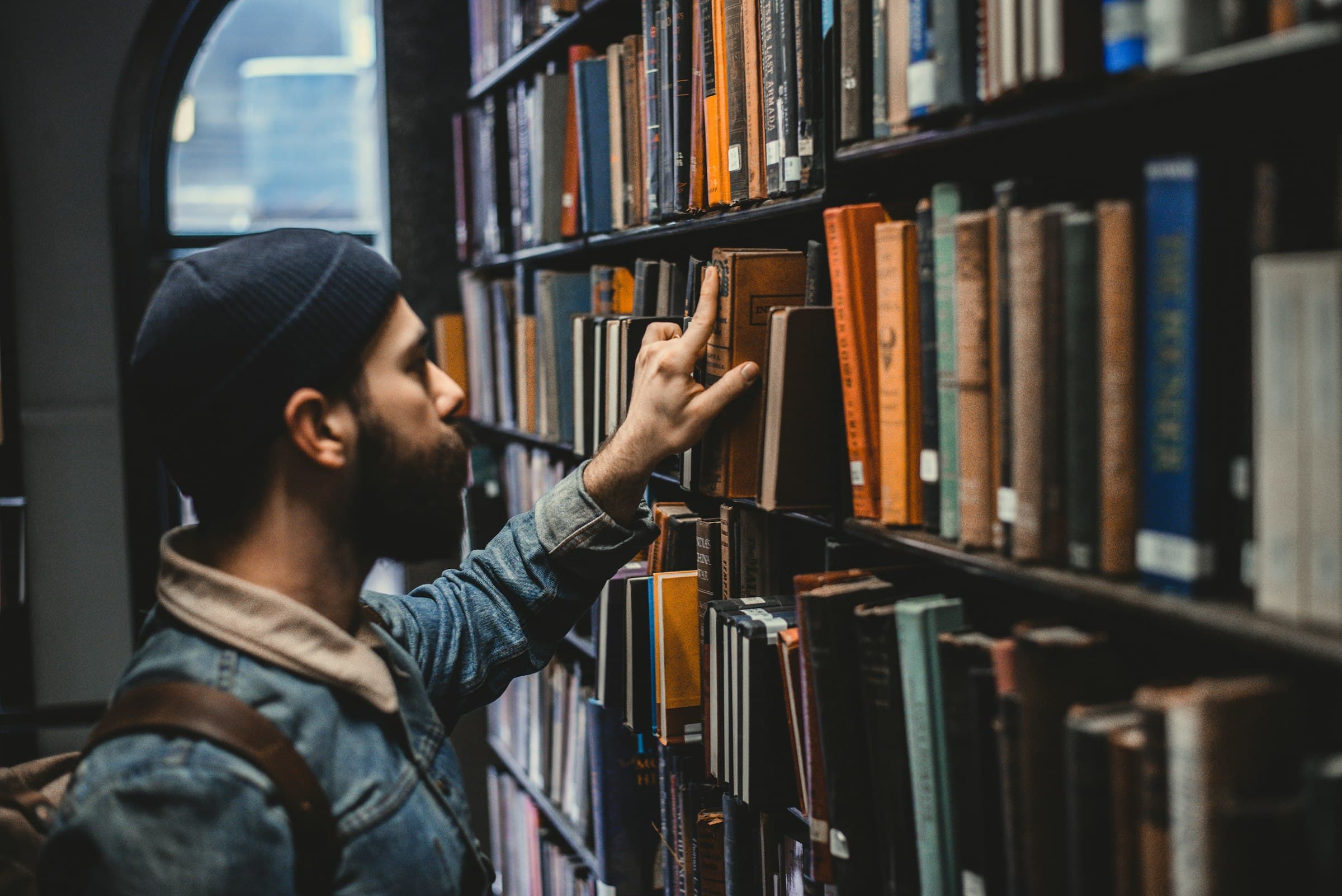 Person browsing books in a library