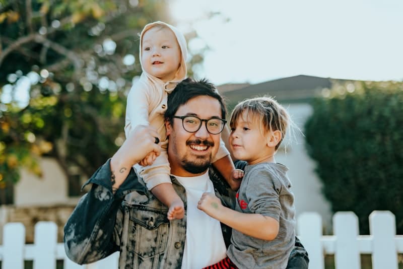 Father with children in front yard — community-focused care